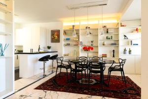 a kitchen and dining room with a table and chairs at Peaceful Penthouse with Garage - NDP Rent in Rome