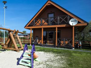 a house with a playground in front of it at Sea view holiday home in Mielno with balcony in Mielno