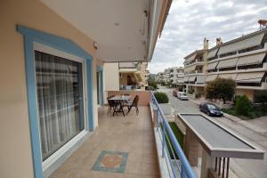 a balcony of a house with a table and chairs at Ioanna's Luxury Two Bedroom Apartment in Nafplio