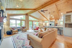 a large living room with couches and a kitchen at Wisconsin Vacation Rental with Fire Pit on Long Lake 