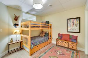 a bedroom with a bunk bed and a night stand at Wisconsin Vacation Rental with Fire Pit on Long Lake 