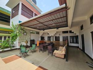 a patio with a table and chairs in a building at Bhaskar Homestay in Dibrugarh