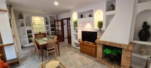 a living room with a fireplace and a table at Miramar Serveis - La Torreta in Cambrils