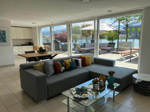 a living room with a couch and a table at Atikka, Penthouse in Lucerne