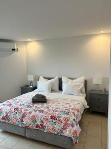 ein Schlafzimmer mit einem großen Bett mit einer Blumendecke in der Unterkunft Atikka, Ático, penthouse in Luzern