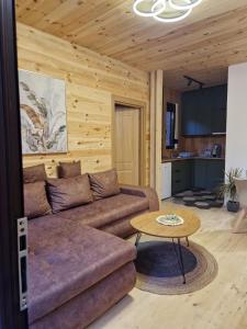 a living room with a couch and a table at OLEA COTTAGE in Ulcinj