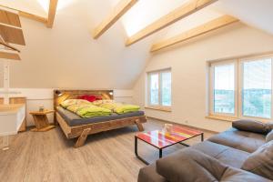 a living room with a couch and a table at Gasthof Wachmann Ferienwohnung in Weiz