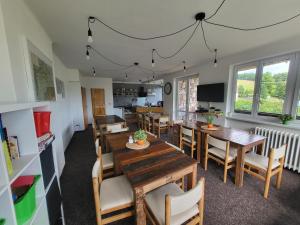 a dining room with wooden tables and chairs at Pension Salma in Černý Dŭl