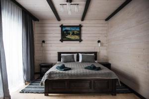 a bedroom with a bed with two hats on it at Chalet Carpat Dream in Synevyr