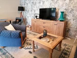 a living room with a tv and a couch and a table at Apartment Apart Waldershof in Waldershof