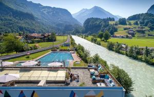 a view of a river with a swimming pool at Villa Sofie in Meiringen