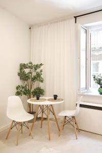 a table and two chairs in a room with a window at Cozy Studio perfect for couples, Cracow Old Town in Krakow