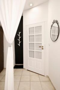 a room with a white door and a mirror at Cozy Studio perfect for couples, Cracow Old Town in Krakow