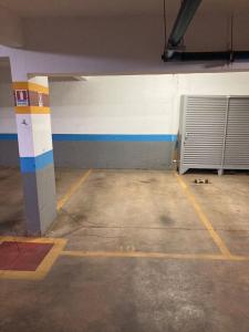 an empty parking garage with a door and a wall at Flat Noroeste Square by CentoEdez in Brasília