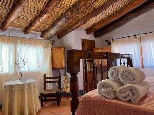 a bedroom with a bed with towels on it at Casa rural La Boticaria in Villar del Arzobispo