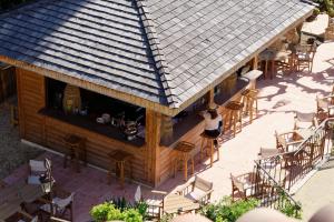 an overhead view of a bar with chairs and tables at La Ferme D'Augustin in Saint-Tropez