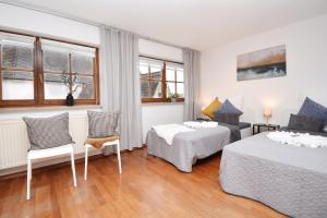 a hotel room with two beds and a couch at NUE11-RI Apartment in Zirndorf in Zirndorf