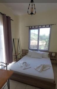 a bedroom with a large bed with a window at Aurora in Potos