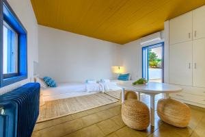 a living room with a table and a couch at Hidesign Athens Villa In Sounio in Sounio
