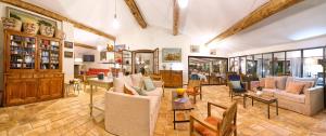 a living room with a lot of chairs and tables at La Ferme D'Augustin in Saint-Tropez