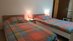 2 Betten nebeneinander in einem Zimmer in der Unterkunft Le moulin neuf - les lilas in Chalandray