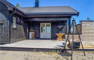 a building with a porch with a swing at 5 Bedroom Stunning Home In Passebekk in Omholt +12 photos