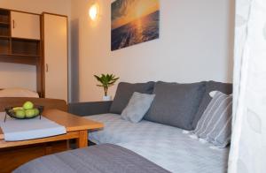 a living room with a couch and a table at Apartment Sun in Baška Voda