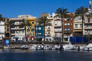 a group of boats docked in a harbor with buildings at TarracoHomes, TH17 Apartamento Vacacional Vintage in Tarragona