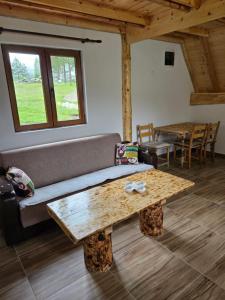 a living room with a couch and a table at Vikendice SMOLOVIC in Žabljak