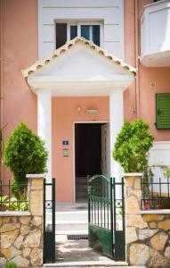 a building with a gate in front of a door at Meropi Apartment in Preveza