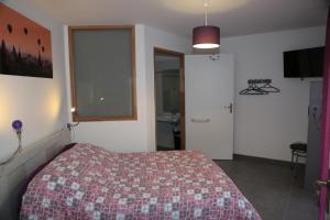 um quarto com uma cama, uma janela e uma casa de banho em Gite montgolfiere em Châtellerault