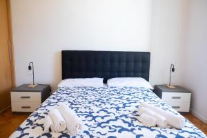 a bedroom with a large bed with towels on it at Seaport #Apartment in Trani