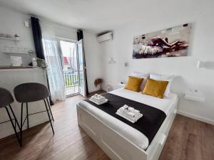 a bedroom with a large bed with yellow pillows at Studio apartments RAFAEL - 4 minutes to the beach in Gradac