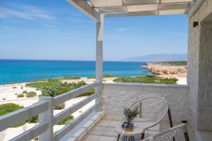 a balcony with a view of the ocean at Ambassador Luxury Villas in Santa Maria