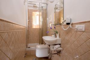 a bathroom with a sink and a shower and a toilet at La Casina Vaticana in Rome