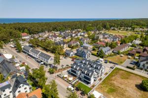 an aerial view of a town with houses at Vellamo Dębki in Dębki