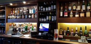 a bar with a lot of bottles of alcohol at Kintail Lodge Hotel in Kyle of Lochalsh