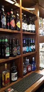 a shelf filled with lots of bottles of beer at Kintail Lodge Hotel in Kyle of Lochalsh