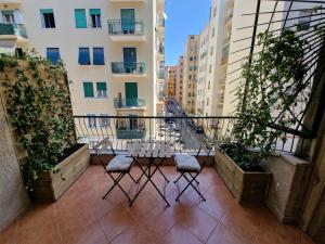 a balcony with two chairs and a table on it at Cuma Suites in Rome
