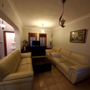 a living room with a couch and a table at Family Holiday House in Aydın