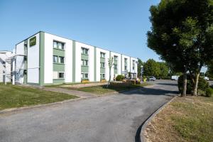 a large white building on a street at greet Chartres Est in Chartres