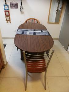 a wooden table with two chairs around a table at Cute Studio near Yad Vashem FREE street parking in Jerusalem