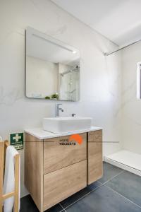 a bathroom with a sink and a mirror at #051 Cosy Apartment close to Beach in Albufeira