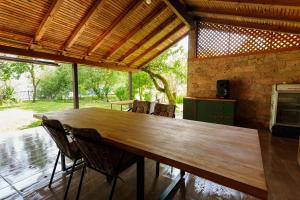 a large wooden table in a kitchen with chairs at Vikendica Gorica-Jablaničko jezero in Konjic