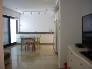 cocina y comedor con mesa y sillas en Royal Service - Bauhaus, en Tel Aviv