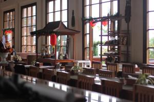 a room with rows of chairs and windows at Jawa Dwipa Heritage Resort in Tawangmangu