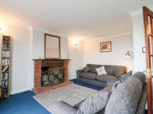 a living room with two couches and a fireplace at Shoreline House in Fraserburgh