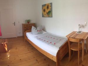 a bedroom with a bed and a desk and a table at Ferienwohnung Fritz in Sigmarszell