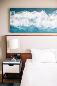 a bedroom with a bed and a table with a lamp at Tampa Marriott Water Street in Tampa