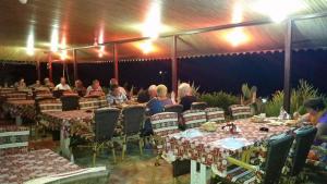 a group of people sitting at tables in a restaurant at Hotel Schönberg in Kızılot +193 photos